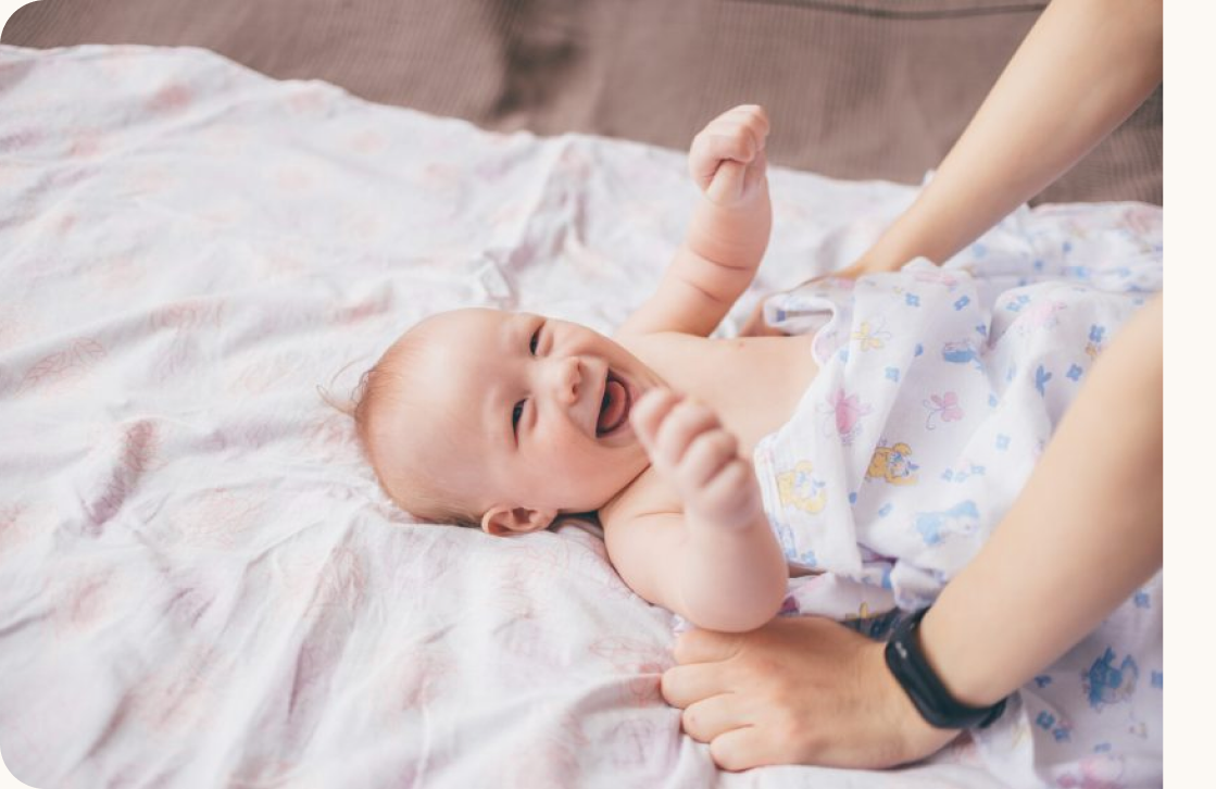 A happy baby being cared for