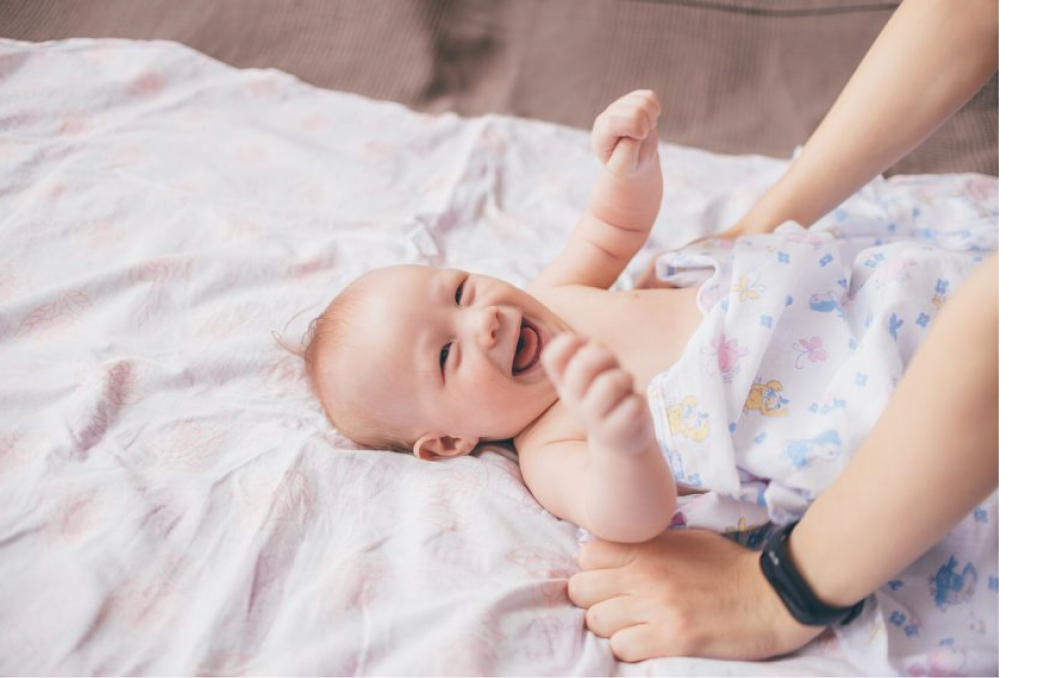 A happy baby being cared for